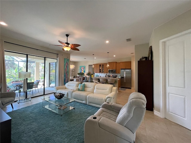 tiled living room featuring ceiling fan