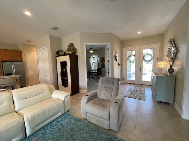 living room featuring light tile patterned floors and french doors