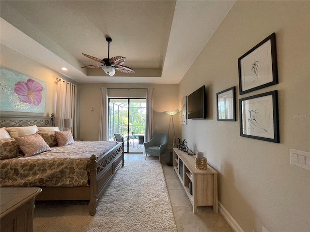 bedroom with ceiling fan, a raised ceiling, and access to outside