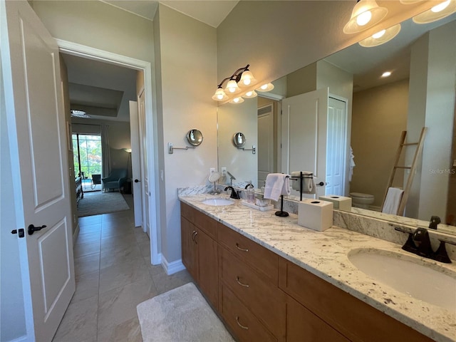 bathroom with tile patterned floors, vanity, and toilet