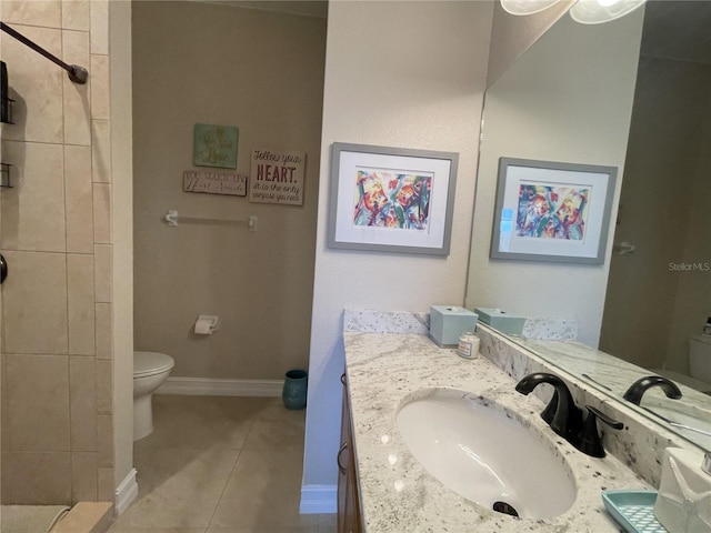 bathroom with vanity, tile patterned floors, and toilet