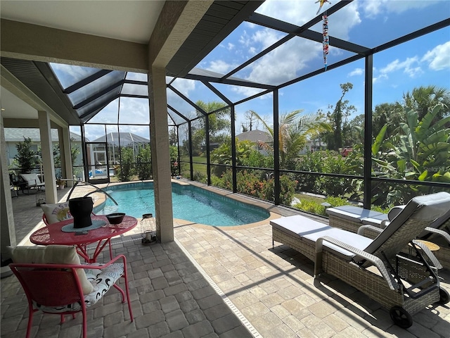 view of swimming pool with glass enclosure and a patio area