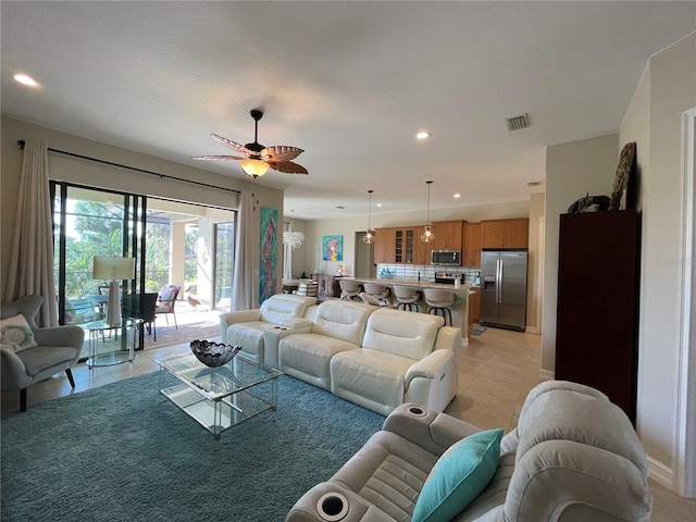 living room with light tile patterned floors and ceiling fan