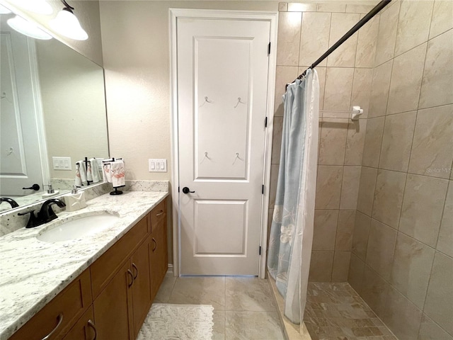 bathroom featuring tile patterned flooring, vanity, and a shower with curtain