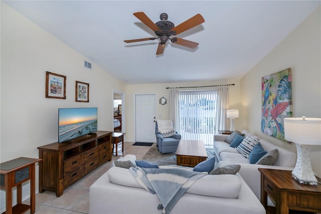 tiled living room with ceiling fan and lofted ceiling