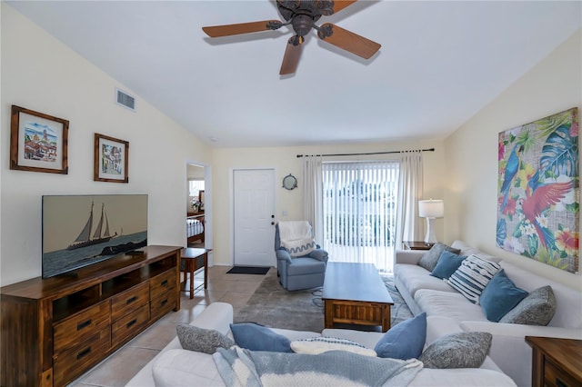 tiled living room featuring ceiling fan and vaulted ceiling