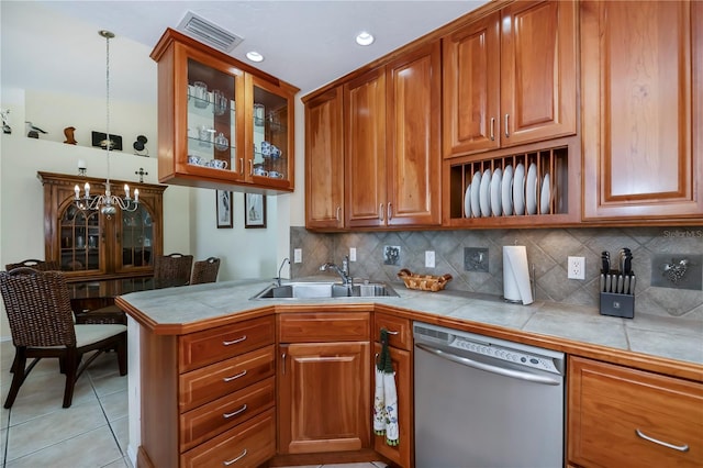 kitchen with tile countertops, sink, hanging light fixtures, stainless steel dishwasher, and light tile patterned floors