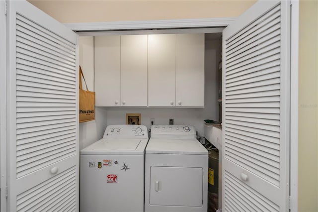 laundry room with cabinets and washer and clothes dryer