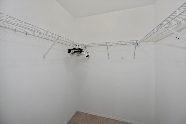 spacious closet with light tile patterned floors