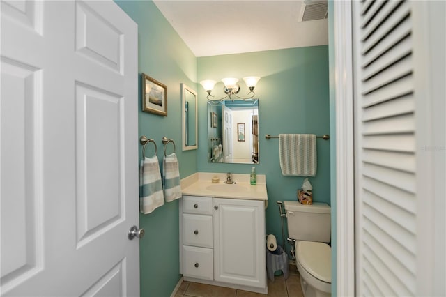 bathroom with tile patterned floors, vanity, and toilet