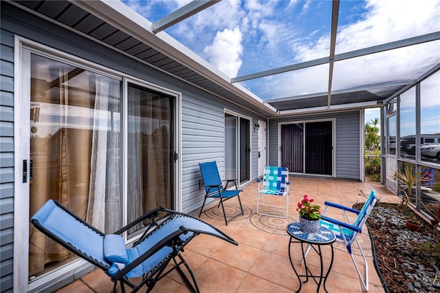 view of patio featuring a lanai