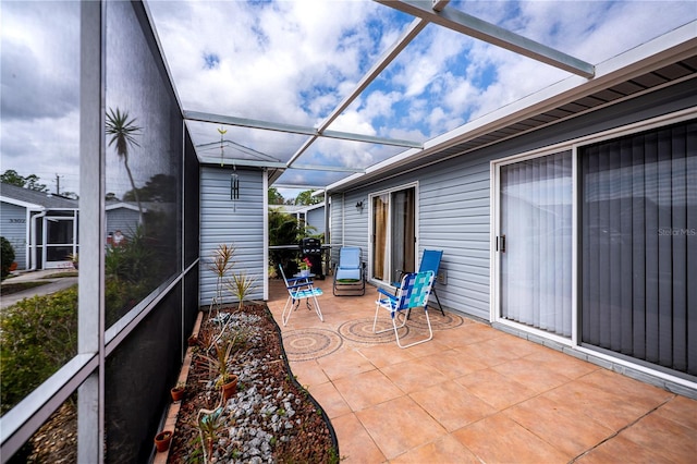 view of patio featuring glass enclosure