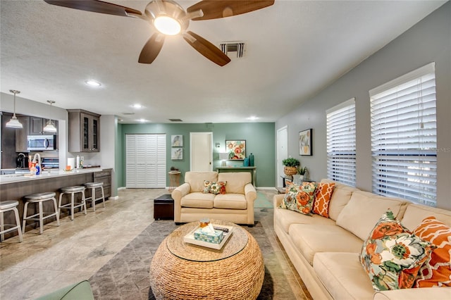 living room with light tile patterned floors and a textured ceiling