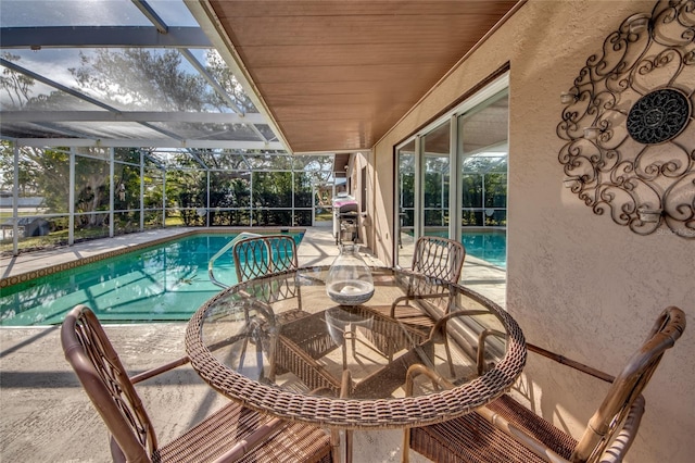 view of swimming pool featuring glass enclosure and a patio area