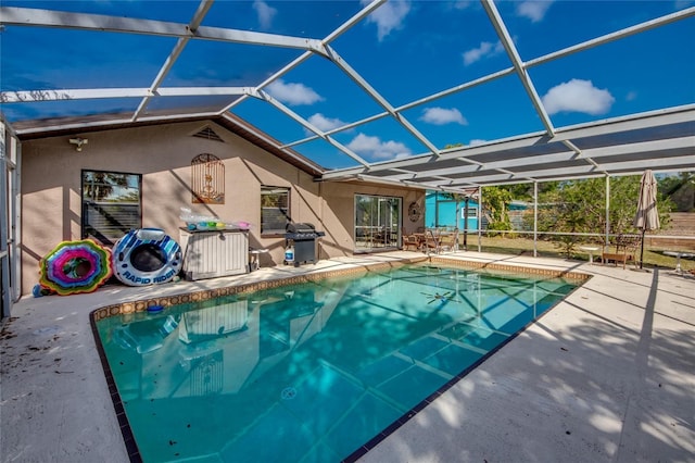 view of swimming pool with a lanai, area for grilling, and a patio