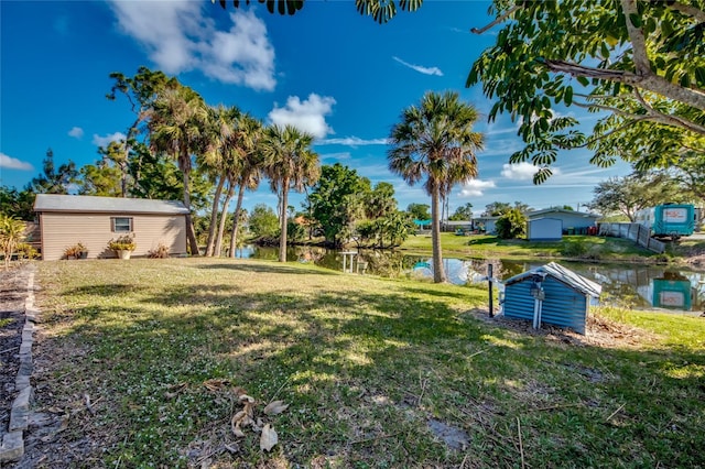 view of yard with a water view and a storage unit