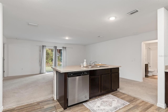 kitchen with sink, dishwasher, dark brown cabinetry, and light carpet