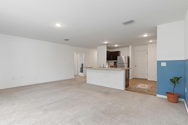 unfurnished living room with light carpet