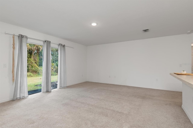 unfurnished room with light colored carpet