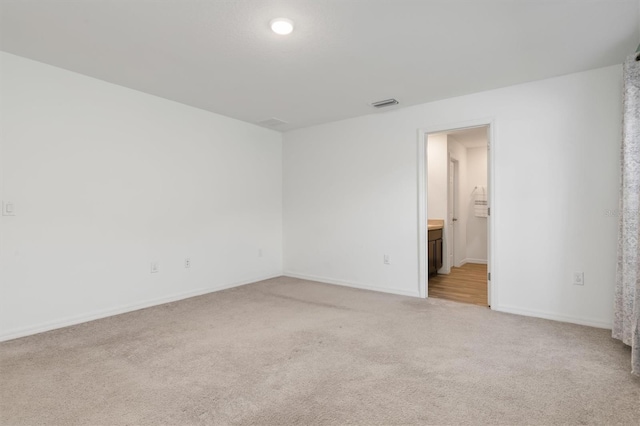 spare room with light carpet