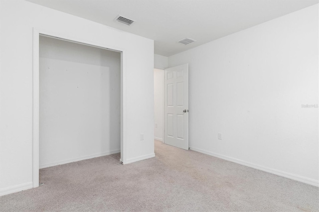 unfurnished bedroom featuring light colored carpet