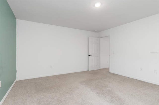 unfurnished room with light carpet