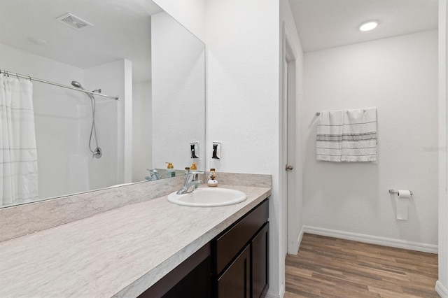 bathroom featuring vanity, a shower with curtain, and wood-type flooring