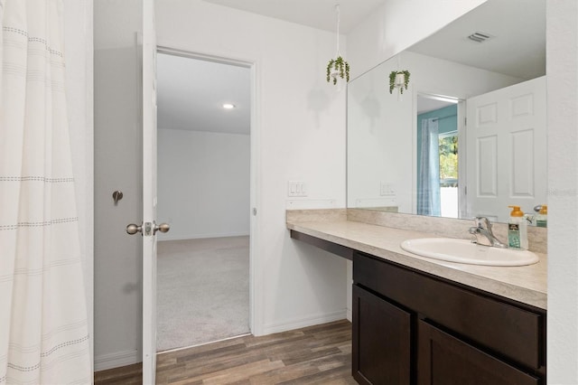 bathroom with vanity and hardwood / wood-style floors