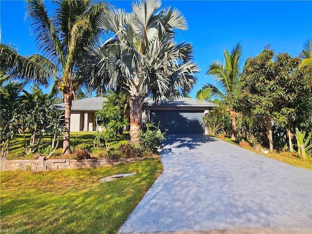 view of front of house with a garage and a front lawn