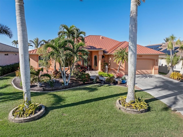 mediterranean / spanish-style home featuring a garage and a front lawn