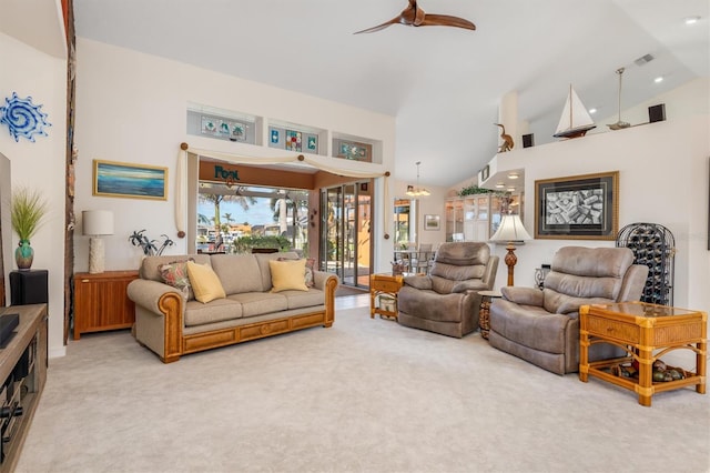 living room featuring light colored carpet, ceiling fan, and lofted ceiling