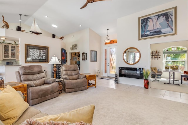 living room featuring light tile patterned floors, high vaulted ceiling, and ceiling fan