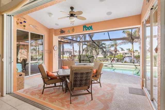 sunroom featuring ceiling fan and vaulted ceiling