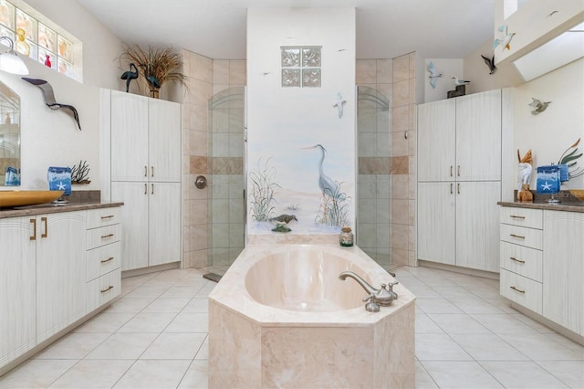 bathroom featuring tile patterned floors, sink, and plus walk in shower