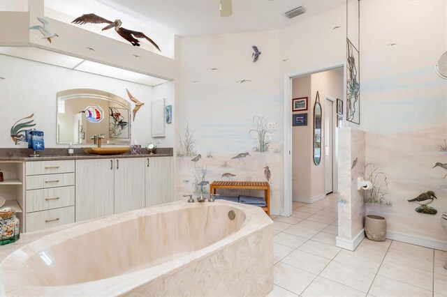 bathroom featuring vanity, tile patterned floors, and tiled tub