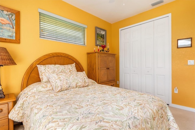 carpeted bedroom featuring ceiling fan and a closet