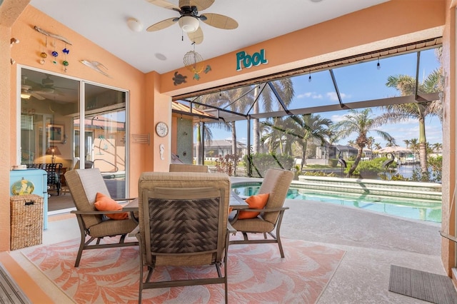 sunroom / solarium with ceiling fan, lofted ceiling, and a swimming pool