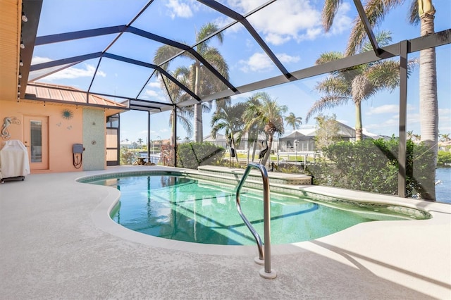 view of swimming pool featuring a patio area and a lanai