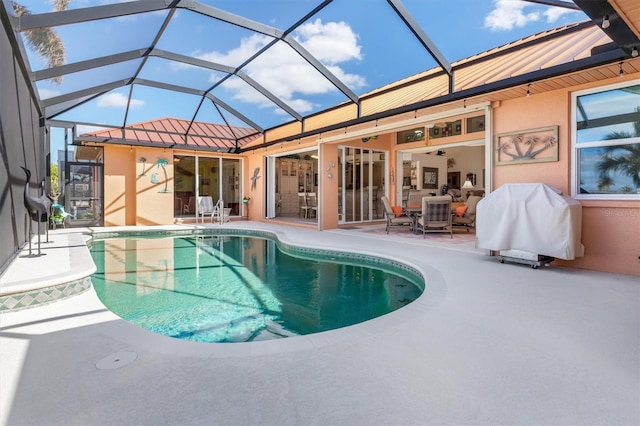 view of pool featuring a lanai, a patio area, and ceiling fan