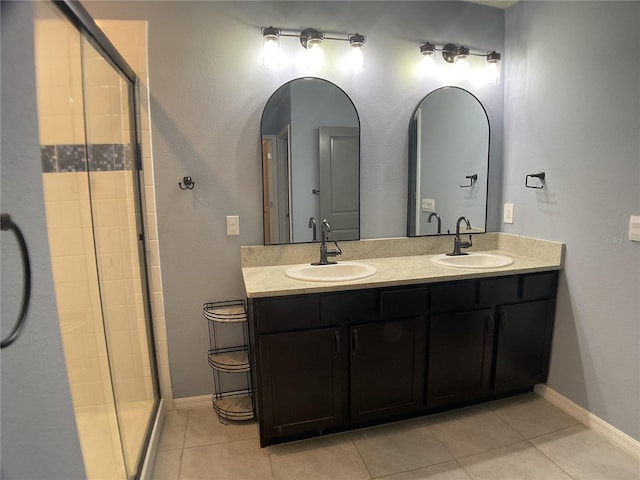 bathroom with tile patterned flooring, vanity, and an enclosed shower