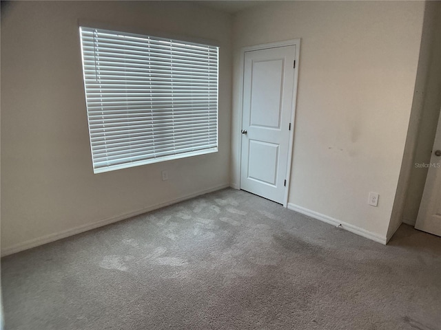 spare room featuring light colored carpet