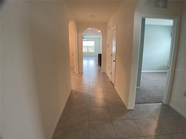 corridor featuring light tile patterned floors