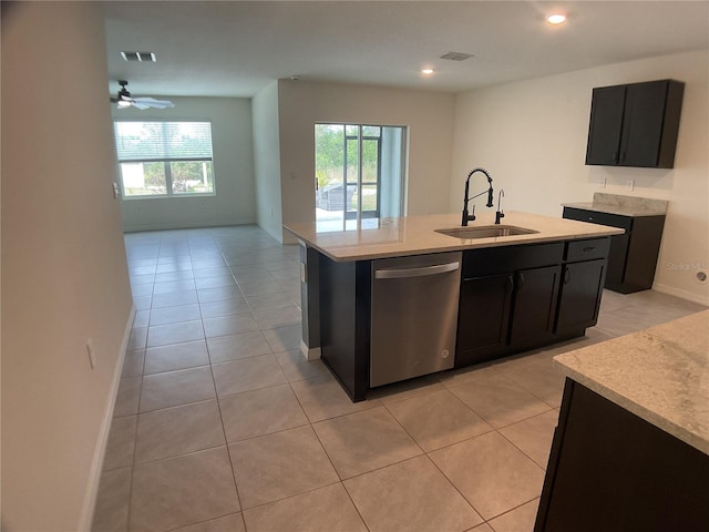 kitchen featuring a center island with sink, dishwasher, light tile patterned flooring, and sink