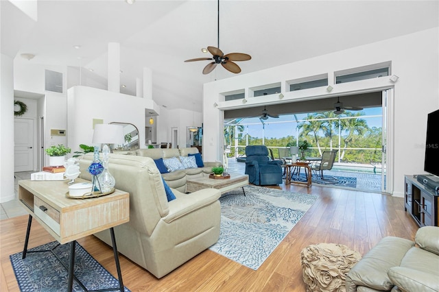 living room featuring light hardwood / wood-style floors and high vaulted ceiling