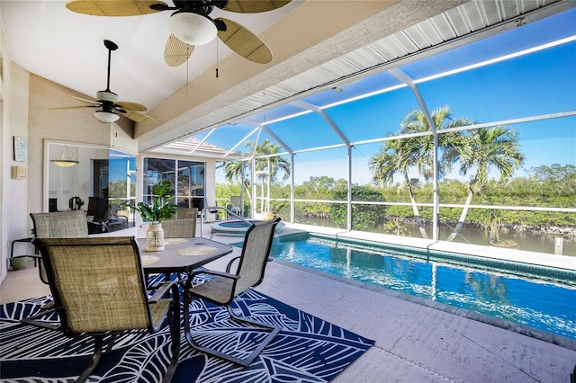 view of pool featuring glass enclosure, a patio area, a water view, and an in ground hot tub