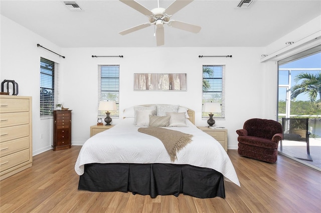 bedroom featuring ceiling fan, access to exterior, light wood-type flooring, and multiple windows