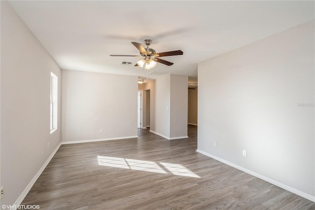 unfurnished room featuring hardwood / wood-style floors and ceiling fan