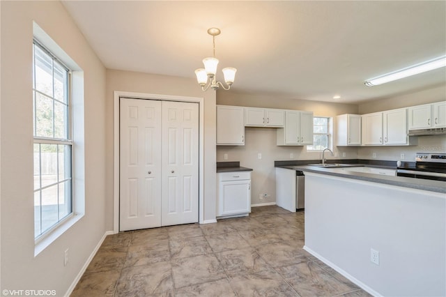 kitchen featuring white cabinets, decorative light fixtures, stainless steel appliances, and a wealth of natural light