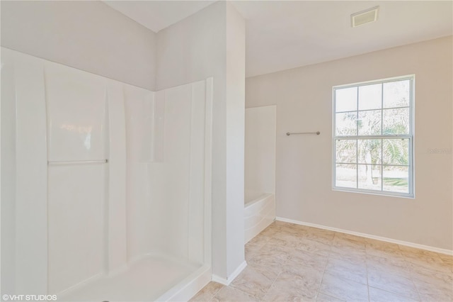 bathroom featuring shower with separate bathtub