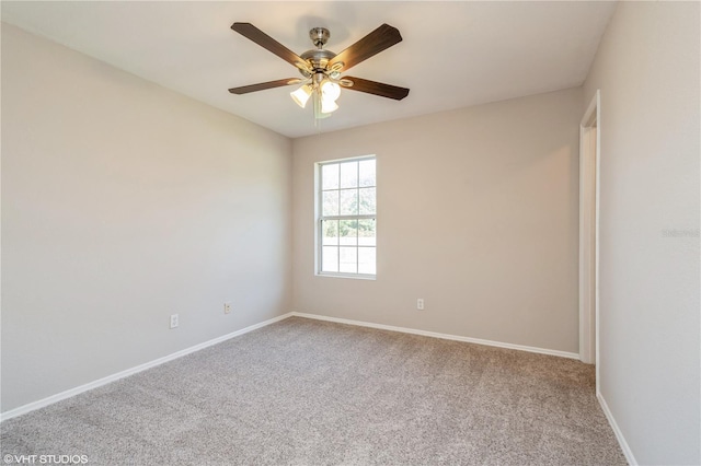 carpeted spare room featuring ceiling fan